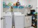 The laundry room offers a washer, dryer, sink, and plenty of shelving for storage at 167 Marlow Dr, Woodstock, GA 30188