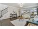 Bright living room with staircase, hardwood floors, and open access to the kitchen at 167 Marlow Dr, Woodstock, GA 30188
