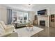 Comfortable living room with fireplace, TV, and ample seating at 167 Marlow Dr, Woodstock, GA 30188
