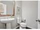 Stylish powder room featuring a pedestal sink, rustic mirror, and neutral decor at 167 Marlow Dr, Woodstock, GA 30188