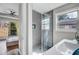 Bathroom featuring modern sink, gray tiled shower with glass door, and a large window at 1988 Boulderview Se Dr, Atlanta, GA 30316