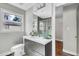 Bathroom boasts stylish vanity with storage, a modern toilet, and a shower with glass door at 1988 Boulderview Se Dr, Atlanta, GA 30316