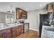 Kitchen with wooden cabinetry, granite countertops, stainless steel appliances, and hardwood floors at 1988 Boulderview Se Dr, Atlanta, GA 30316
