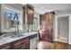 Well-lit kitchen showcases granite counters, dark cabinets, stainless steel appliances, and hardwood floors at 1988 Boulderview Se Dr, Atlanta, GA 30316