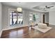 Sun-filled living room featuring hardwood floors, neutral paint, statement lighting, and two large windows at 1988 Boulderview Se Dr, Atlanta, GA 30316