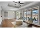 Open-concept living room with hardwood floors, tray ceiling, lots of windows, and stylish furnishings at 1988 Boulderview Se Dr, Atlanta, GA 30316