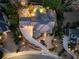 Night aerial view of home showcasing lush landscaping, driveway, patio, and sparkling pool, highlighting the property's layout at 2146 Wolbert Trl, Marietta, GA 30062