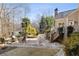 Landscaped backyard with a stone patio, a spa, and mature trees at 2146 Wolbert Trl, Marietta, GA 30062