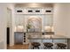 Elegant bar area featuring custom cabinetry, stone backsplash, granite countertop, and stainless steel beverage cooler at 2146 Wolbert Trl, Marietta, GA 30062