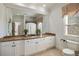 Bathroom featuring an oversized mirror, marble countertops, custom cabinetry, and tile floors at 2146 Wolbert Trl, Marietta, GA 30062