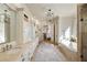 A well-lit bathroom featuring an expansive vanity area, jacuzzi tub, and decorative pendant lighting at 2146 Wolbert Trl, Marietta, GA 30062