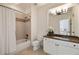 Well-lit bathroom featuring a shower-tub combination, granite counters, and a view into a bedroom at 2146 Wolbert Trl, Marietta, GA 30062