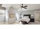 Well-lit bedroom featuring neutral walls, plush carpet, a ceiling fan, and a decorative wall map at 2146 Wolbert Trl, Marietta, GA 30062