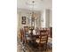Cozy dining room with decorative chandelier, seating for eight, and hardwood floors at 2146 Wolbert Trl, Marietta, GA 30062