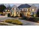 Stately two-story home with manicured landscaping, elegant lighting, and a circular driveway at 2146 Wolbert Trl, Marietta, GA 30062