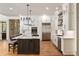 Bright kitchen featuring a central island with seating, stainless steel appliances, and custom cabinetry at 2146 Wolbert Trl, Marietta, GA 30062