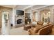 Elegant living room featuring hardwood floors, exposed brick, a fireplace, and a seating area at 2146 Wolbert Trl, Marietta, GA 30062