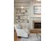 Bright living room with fireplace, built-in shelving, and a cozy armchair at 2146 Wolbert Trl, Marietta, GA 30062