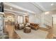 Elegant living room featuring hardwood floors, exposed brick, an arched entryway, and a stairwell at 2146 Wolbert Trl, Marietta, GA 30062