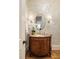 Charming powder room featuring elegant wallpaper, a marble vanity, and decorative lighting at 2146 Wolbert Trl, Marietta, GA 30062