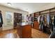 Spacious walk-in closet featuring custom shelving and storage, a center island and hardwood floors at 2146 Wolbert Trl, Marietta, GA 30062