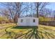 A bright white storage shed in the backyard with trees surrounding it at 2804 Freemans Mill Rd, Dacula, GA 30019