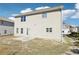 Backyard view of home with neutral siding, a small patio, and multiple windows for natural light at 7783 Hansel Ln, Lithonia, GA 30058