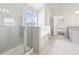 Bright en suite bathroom featuring shower, bathtub, and double sinks at 7783 Hansel Ln, Lithonia, GA 30058