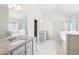 En suite bathroom featuring double sinks, bathtub, and glass shower at 7783 Hansel Ln, Lithonia, GA 30058