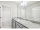 A bathroom featuring granite countertop, neutral cabinets, tile floors and a bath tub at 7783 Hansel Ln, Lithonia, GA 30058