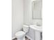 Powder bathroom features a pedestal sink, tiled flooring, and neutral paint at 7783 Hansel Ln, Lithonia, GA 30058