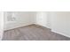 A bedroom featuring neutral walls, carpets and a window providing natural light at 7783 Hansel Ln, Lithonia, GA 30058