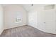 A bedroom featuring neutral walls, carpets, a closet and a window providing natural light at 7783 Hansel Ln, Lithonia, GA 30058