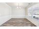 Bright dining area featuring elegant trim work, laminate floors, and a large window at 7783 Hansel Ln, Lithonia, GA 30058