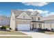 Charming two-story home with a well-maintained lawn and an attached two-car garage at 7783 Hansel Ln, Lithonia, GA 30058