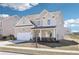 Charming two-story home with a well-maintained lawn and an attached two-car garage at 7783 Hansel Ln, Lithonia, GA 30058