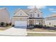 Charming two-story home with a well-maintained lawn and an attached two-car garage at 7783 Hansel Ln, Lithonia, GA 30058