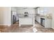 Modern kitchen with center island, stainless appliances, and gray shaker cabinets at 7783 Hansel Ln, Lithonia, GA 30058