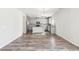 Modern kitchen with stainless appliances and gray cabinets open to living area at 7783 Hansel Ln, Lithonia, GA 30058