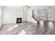 Spacious open area featuring wood floors, fireplace, and a stairway with natural lighting at 7783 Hansel Ln, Lithonia, GA 30058