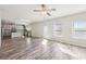 Spacious living room with wood floors connects to a kitchen featuring modern finishes at 7783 Hansel Ln, Lithonia, GA 30058