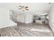 Open-concept layout with wood floors connecting the staircase and kitchen area at 7783 Hansel Ln, Lithonia, GA 30058