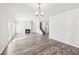 Large open area featuring wood flooring, fireplace, and abundant natural light at 7783 Hansel Ln, Lithonia, GA 30058