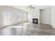 Bright living area features modern fireplace, wood floors, and natural light at 7783 Hansel Ln, Lithonia, GA 30058