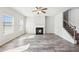 Open living room with fireplace and stairway with wrought iron and stained wood at 7783 Hansel Ln, Lithonia, GA 30058