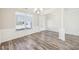 Bright living area featuring elegant trim work, laminate floors, and a large window at 7783 Hansel Ln, Lithonia, GA 30058
