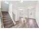 Inviting entry with staircase, laminate floors, and open layout to the living and dining area at 7783 Hansel Ln, Lithonia, GA 30058