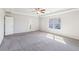Large carpeted primary bedroom offers lots of natural light and neutral paint at 7783 Hansel Ln, Lithonia, GA 30058