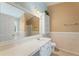 Well-lit bathroom with ample vanity space and storage shelves at 240 Village Square Dr, Woodstock, GA 30188