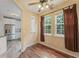 Cozy breakfast nook with large windows, hardwood floors, and an adjacent open kitchen at 240 Village Square Dr, Woodstock, GA 30188